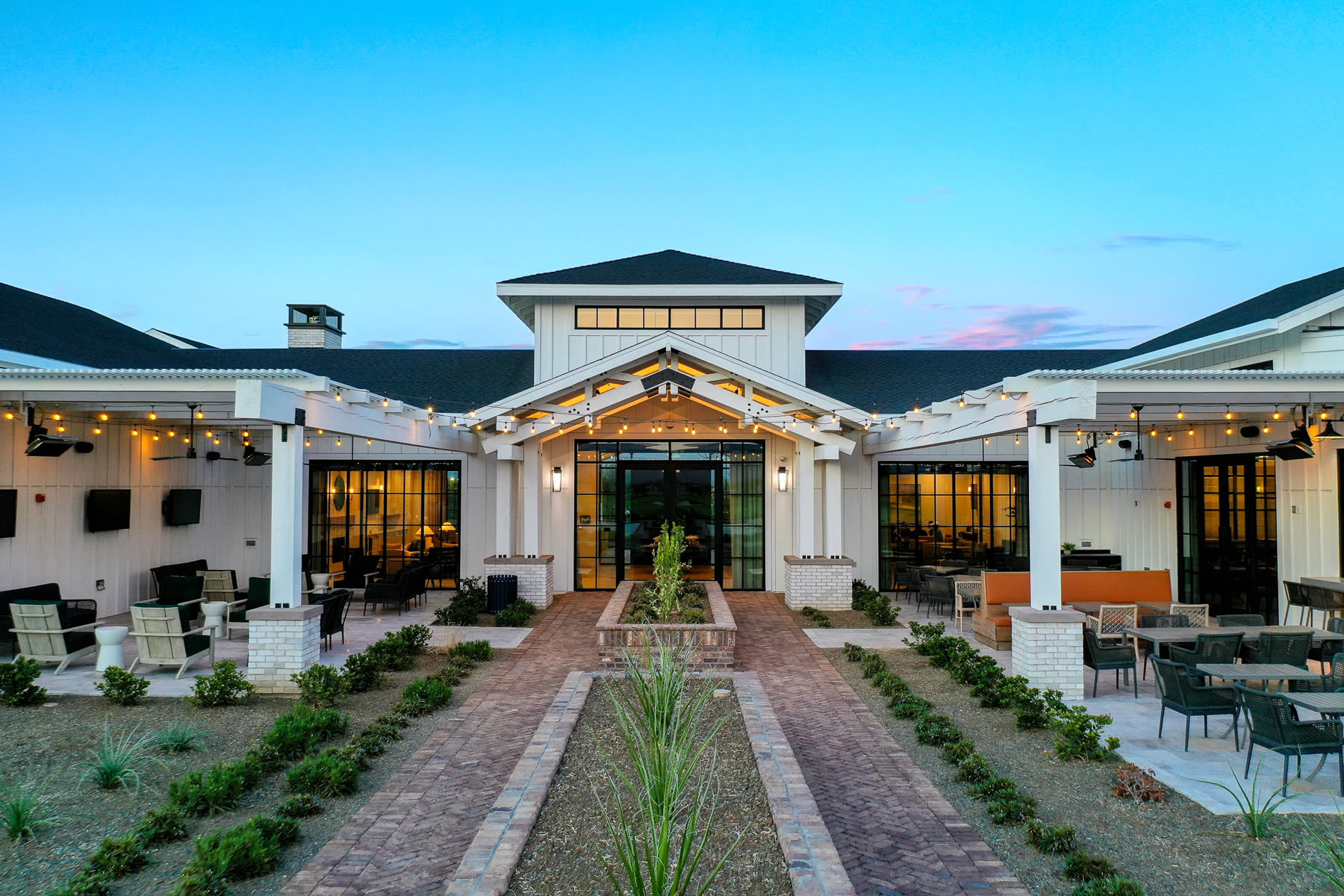 Twilight photograph of a community clubhouse courtyard